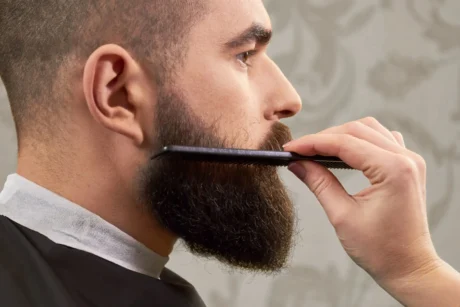 combing his beard